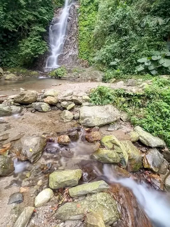 Sakul Waterfall cascading down vertical rock face surrounded by greenery Hualien — Taiwan Insider